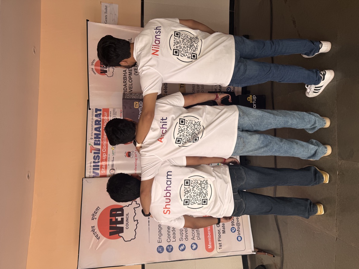 Nimitai team wearing branded t-shirts with QR codes in front of Viksit Bharat standee at RTMNU Nagpur